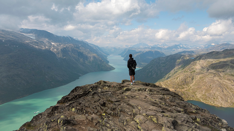 Hiker at Besseggen overlooking Gjende Fjord