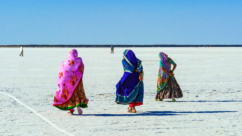 colorfully dressed women in desert
