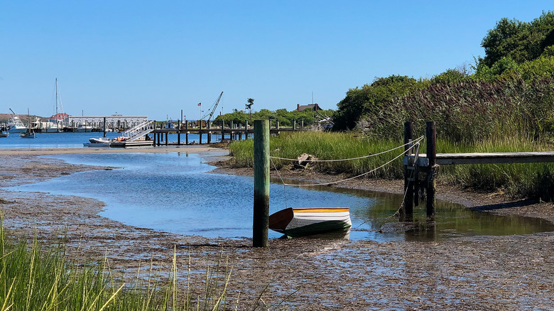 Low tide in a protected harbor with a boat