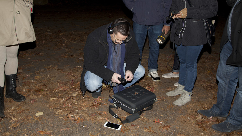 Paranormal investigator checking gear