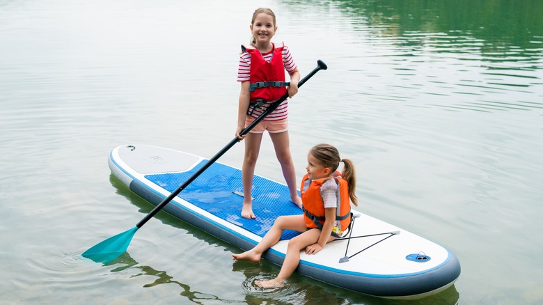 Kids paddleboarding on a lake