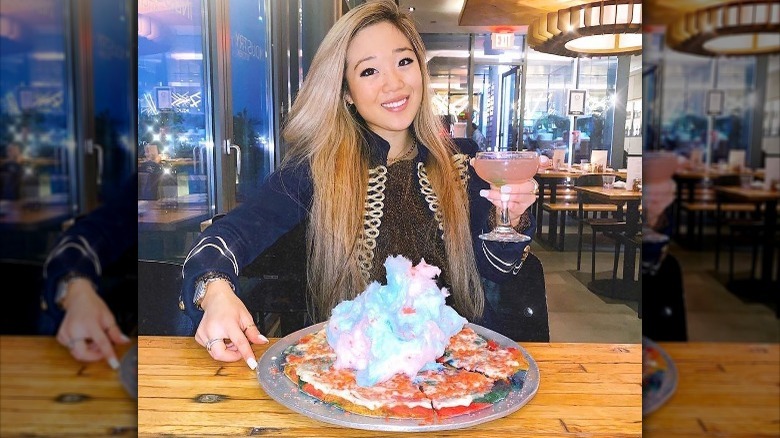 Diner posing with Pop Candy Land pizza