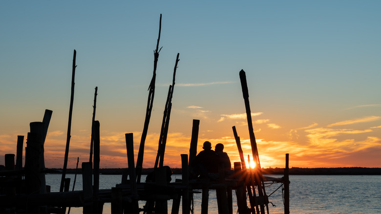 Watching sunset on a dock in Comporta, Portugal