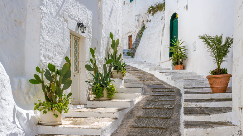 Staircase winding between white buildings in Ostuni, Italy