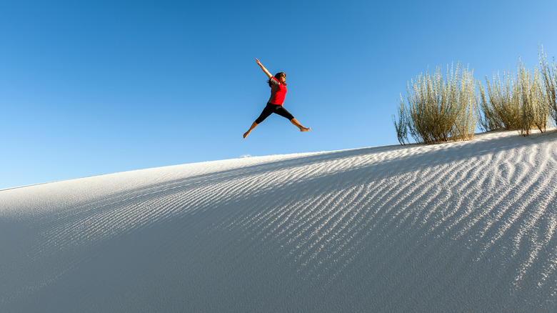 Woman jumping at White Sands