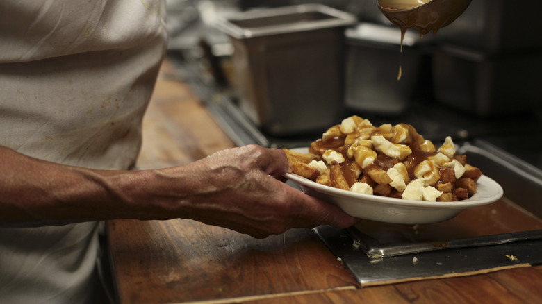 chef creating a poutine dish 
