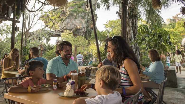 Family eating at table at Disney