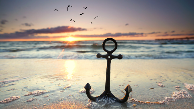 anchor on sunsetting beach 