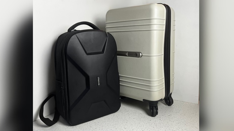 Suitcase next to a backpack