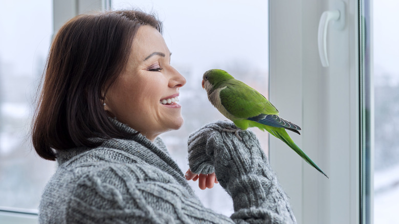 smiling woman holding bird