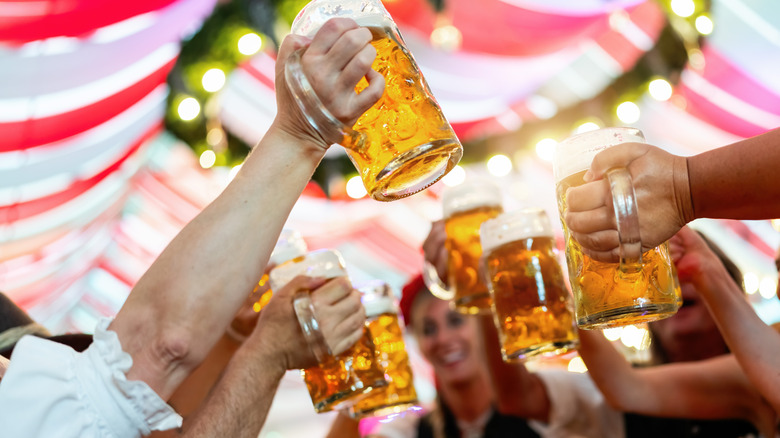 People clinking beer glasses