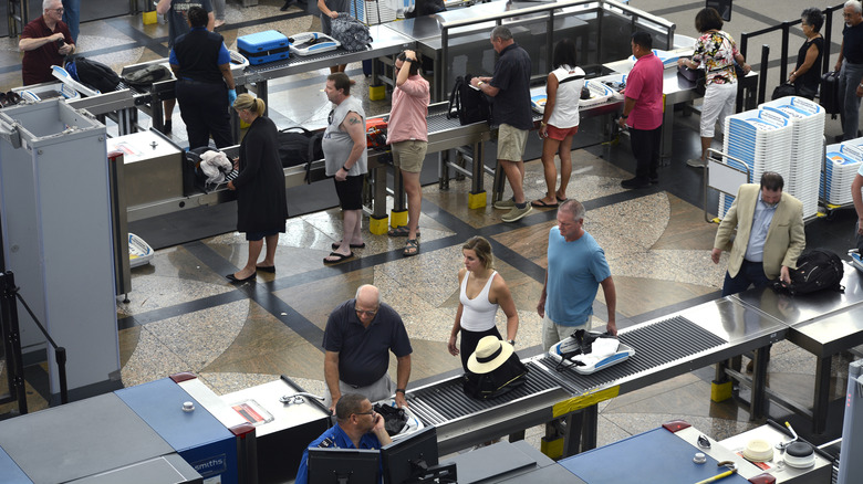 travelers in airport TSA line