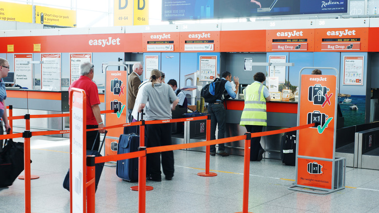 Passengers at easyJet check-in with baggage checks