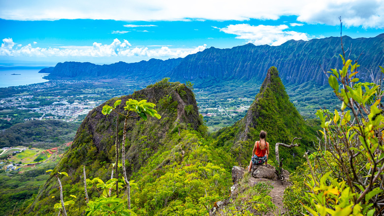 A woman hikes the Three Peaks trail on Oahu