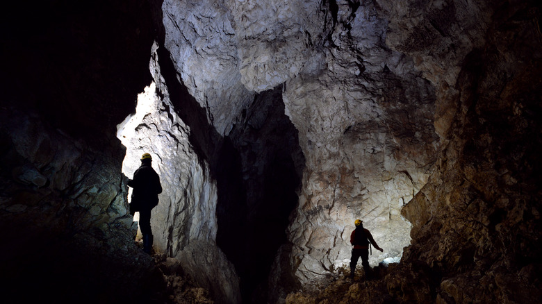 Cave explorers wearing headlamps 