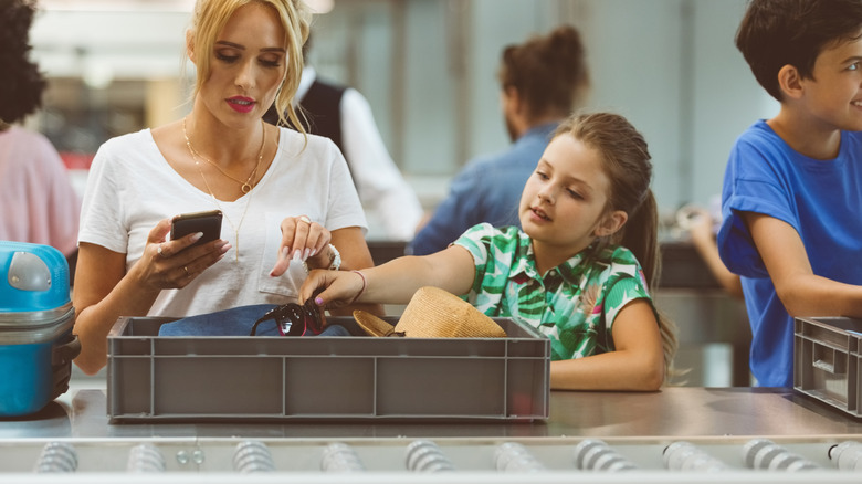 Traveling family passing through airport security