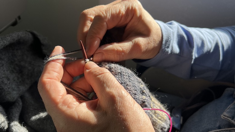 Traveler knitting on an airplane