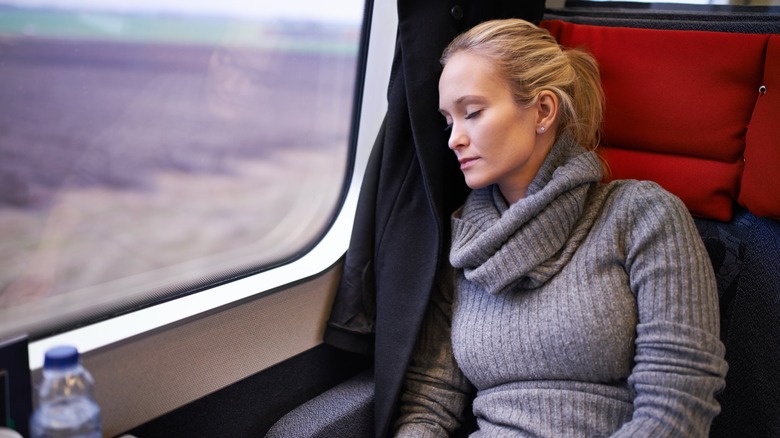 woman sleeping on train