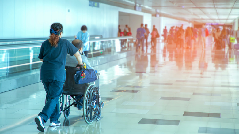 nurse with wheelchair at airport