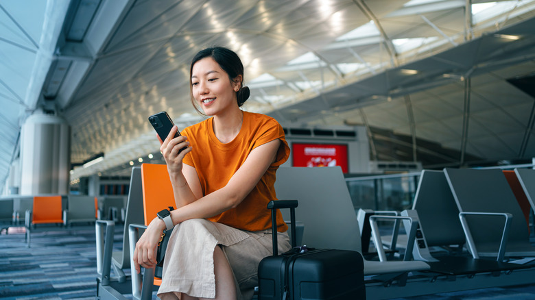 Traveler sitting near boarding gate