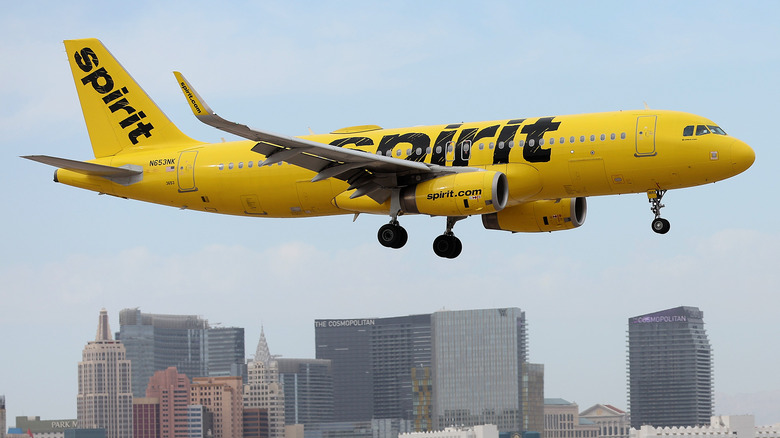 Spirit Airline flying over buildings