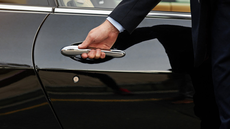 Chauffeur opening a car door