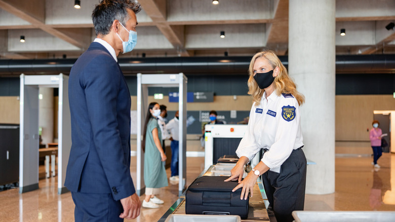 Security officer checking passenger's hand luggage