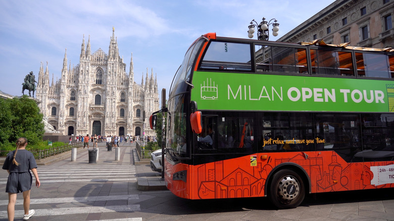 A bus driving near the Duomo in Milan, Italy