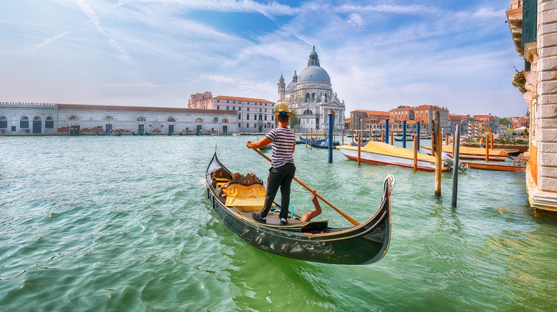 gondola being poled through Venice