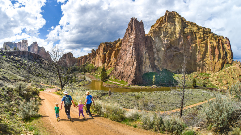 Two children walk with parents through Smith Rock State Park