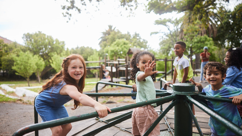 Kids laughing as they play together at a city park