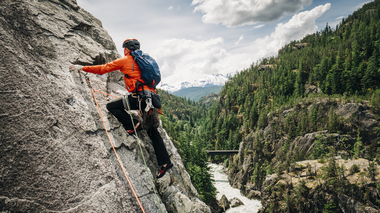 Person rock climbing in wilderness area