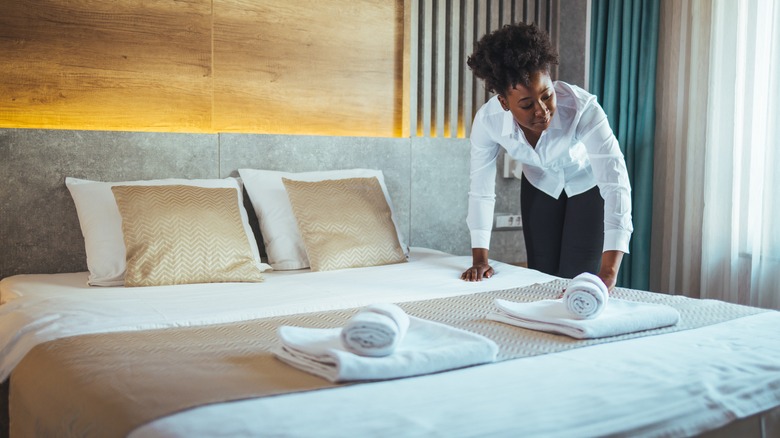 Woman making hotel bed