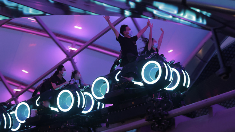 People riding Tron Lightcycle