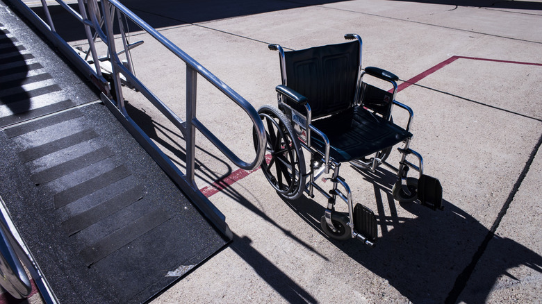 Wheelchair next to airplane ramp