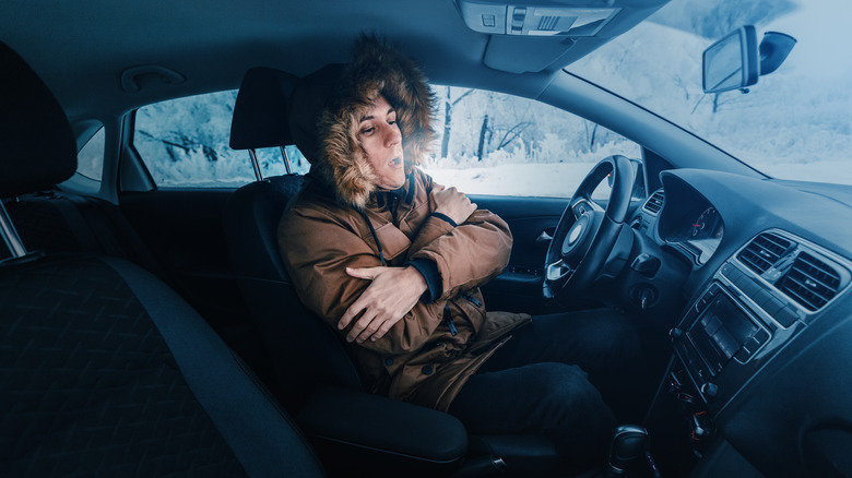 Driver staying warm inside freezing car