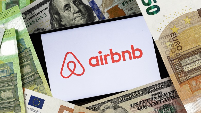 airbnb on phone in pile of money