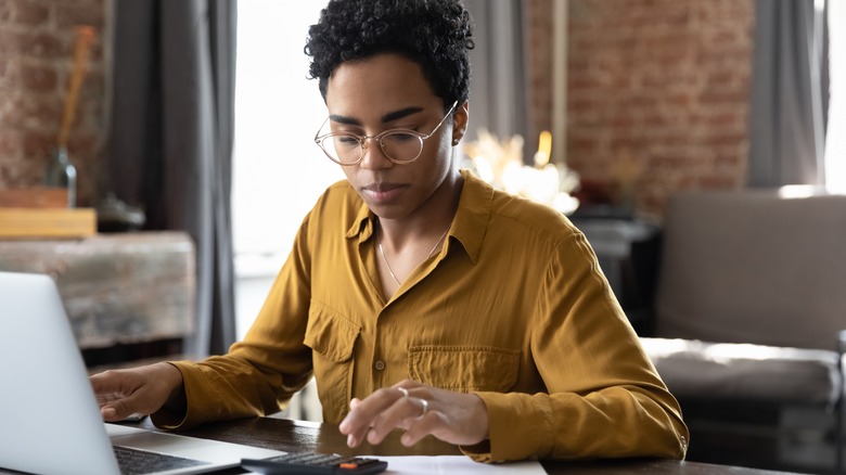 Woman with laptop and calculator