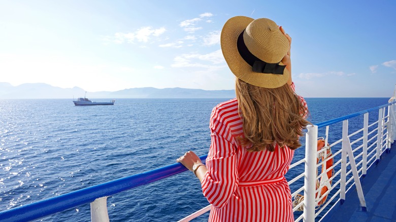 Woman on ship deck looking out