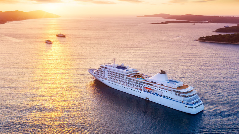cruise ship sailing at sunset