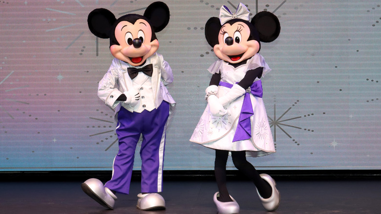 Minnie and Mickey in their 100th costumes