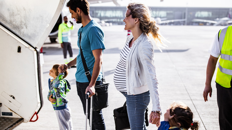 Pregnant woman boarding plane