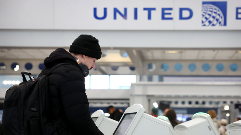 man checking into United flight