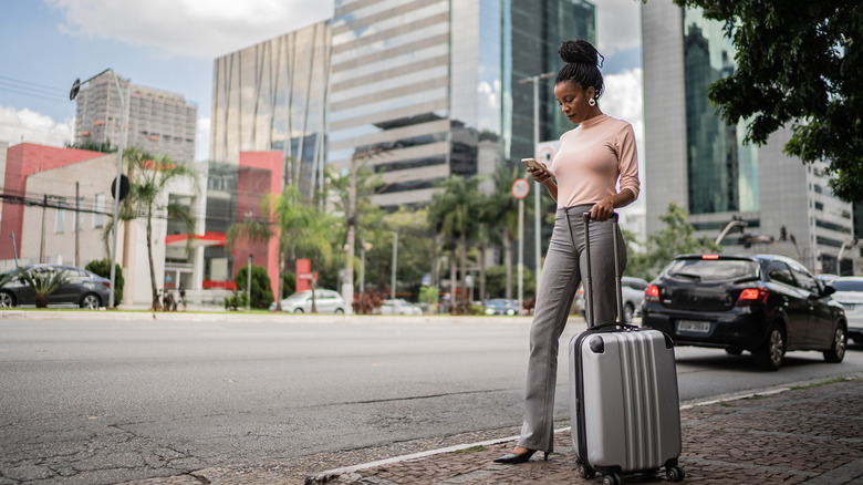 woman standing with luggage