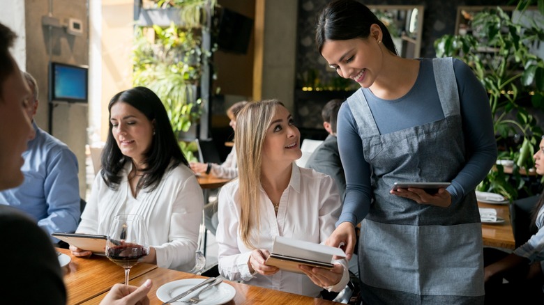 woman talking to restaurant server