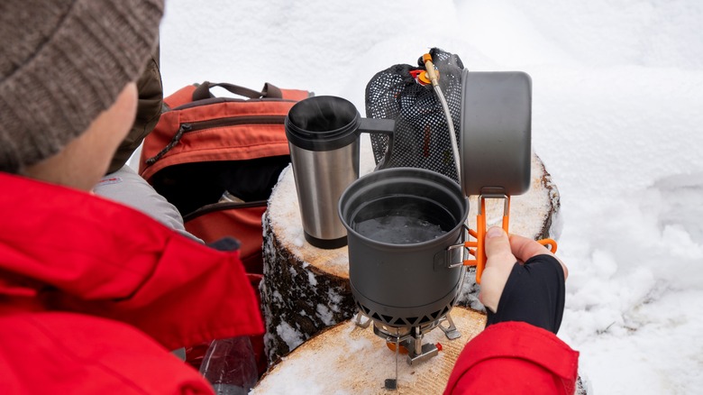 Preparing drink in the snow