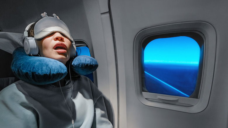 Woman sleeping in her airplane seat