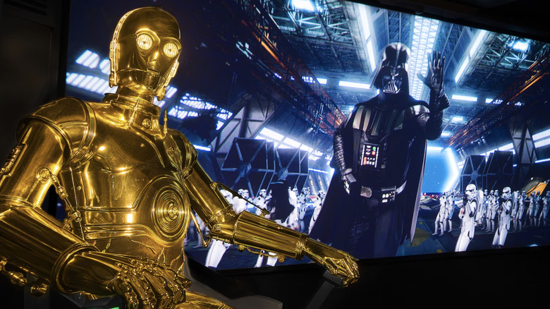 C-3P0 with Darth Vader on screen