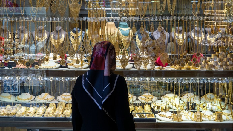 Woman looking at gold jewelry 