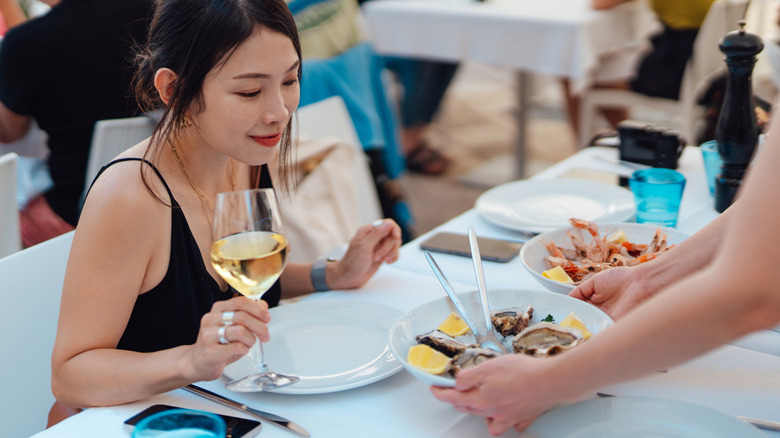 woman receiving a meal at a restaurant